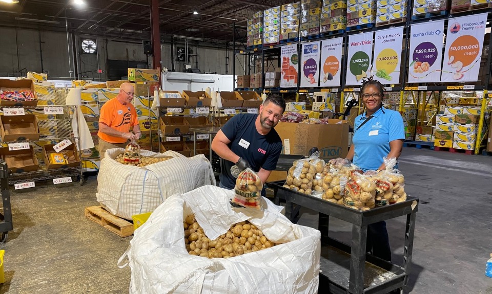 Volunteers packing potatoes at Feeding Tampa Bay