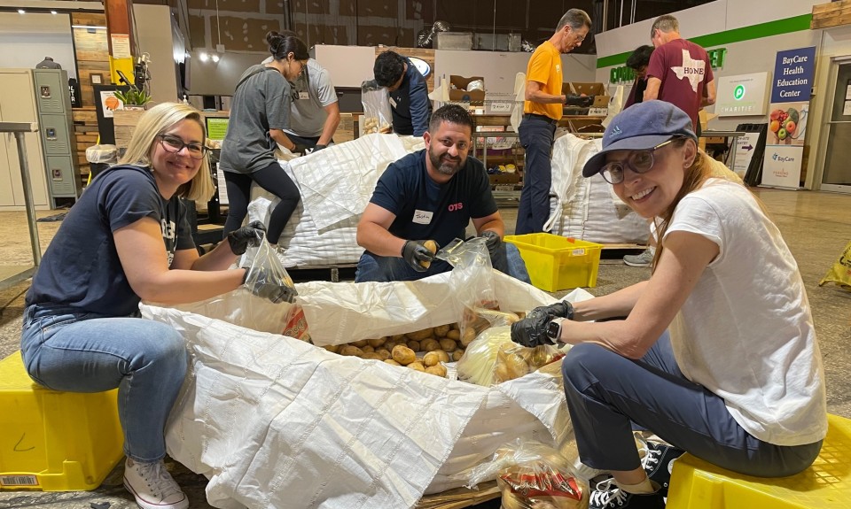 Volunteers packing potatoes at Feeding Tampa Bay