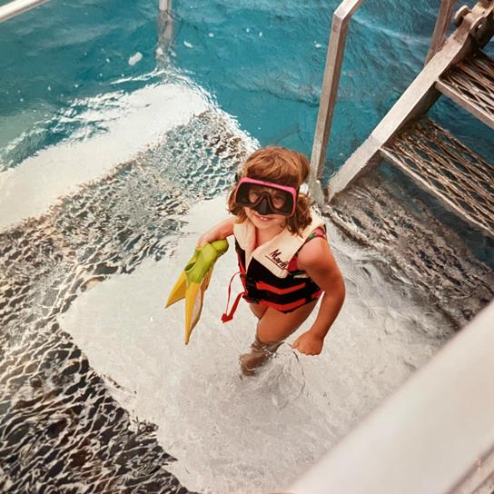 Ashley as a child snorkeling at the Great Barrier Reef in Australia