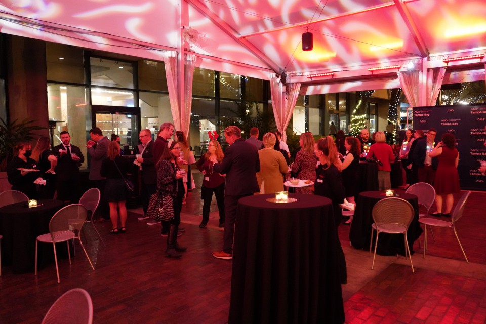 Members and guests enjoy the mixer in a tent outside the Straz Center